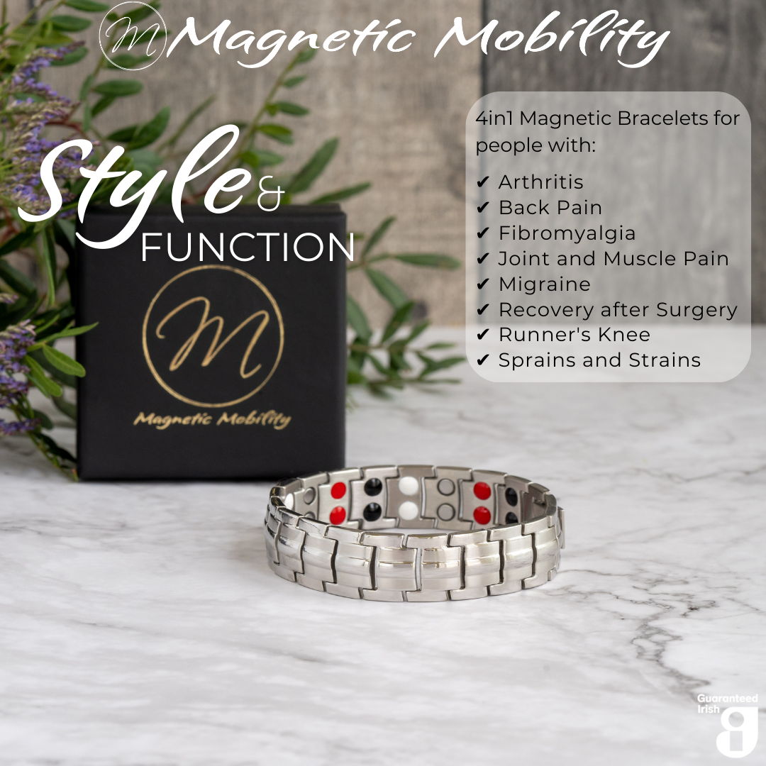 Front view of the Ashe Star Double strength 4in1 magnetic bracelet by Magnetic Mobility, promoting arthritis, back pain, fibromyalgia relief with a stylish black design. The bracelet is shown in front of its luxury Black gift box and flowers.