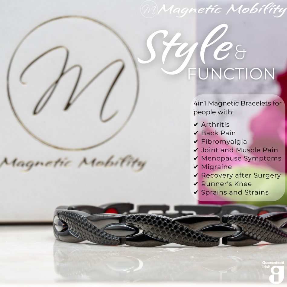 Close up view of the Snapdragon Night 4in1 magnetic bracelet by Magnetic Mobility. Shown on a reflective surface with pink flowers in the background. The text says "Style and Function"