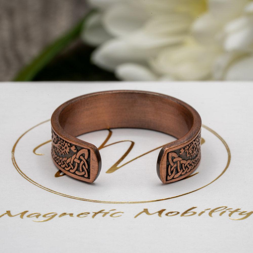 Rear view of the Buckthorn copper ring from Magnetic Mobility, highlighting the adjustable open back feature. The Tree of Life design adds a touch of elegance to this functional ring, perfect for arthritic fingers.