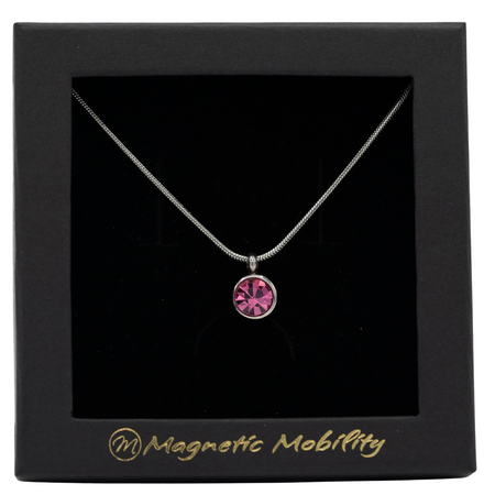 October Magnetic Mobility Birthstone Necklace featuring a pink Swarovski crystal pendant with a magnetic back. Ideal for relieving neck pain, displayed in a black box with Magnetic Mobility logo.