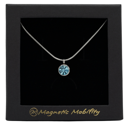 March Birthstone Necklace by Magnetic Mobility featuring a light blue Swarovski crystal pendant with a magnet. Perfect for neck pain relief, displayed in elegant black packaging.